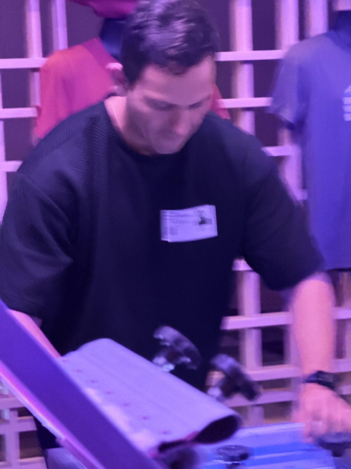 Guests watching a printer pull a squeegee at a San Francisco event
